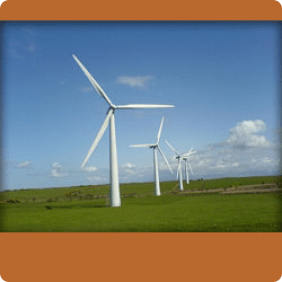 large open paddock with 4 wind turbines